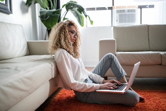 woman sitting on floor with laptop